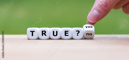 True? Hand turns a dice and changes the word "no" to "yes"