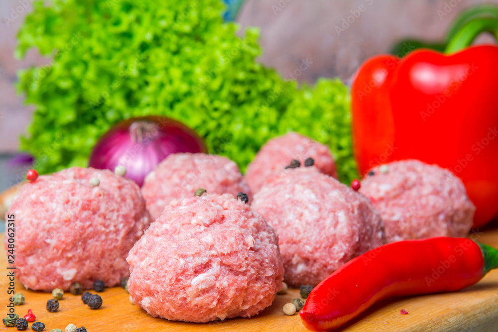 raw mince patties in a cooking . cutlets are prepared for cutting board raw mince patties in a cooking . cutlets are prepared for cutting board