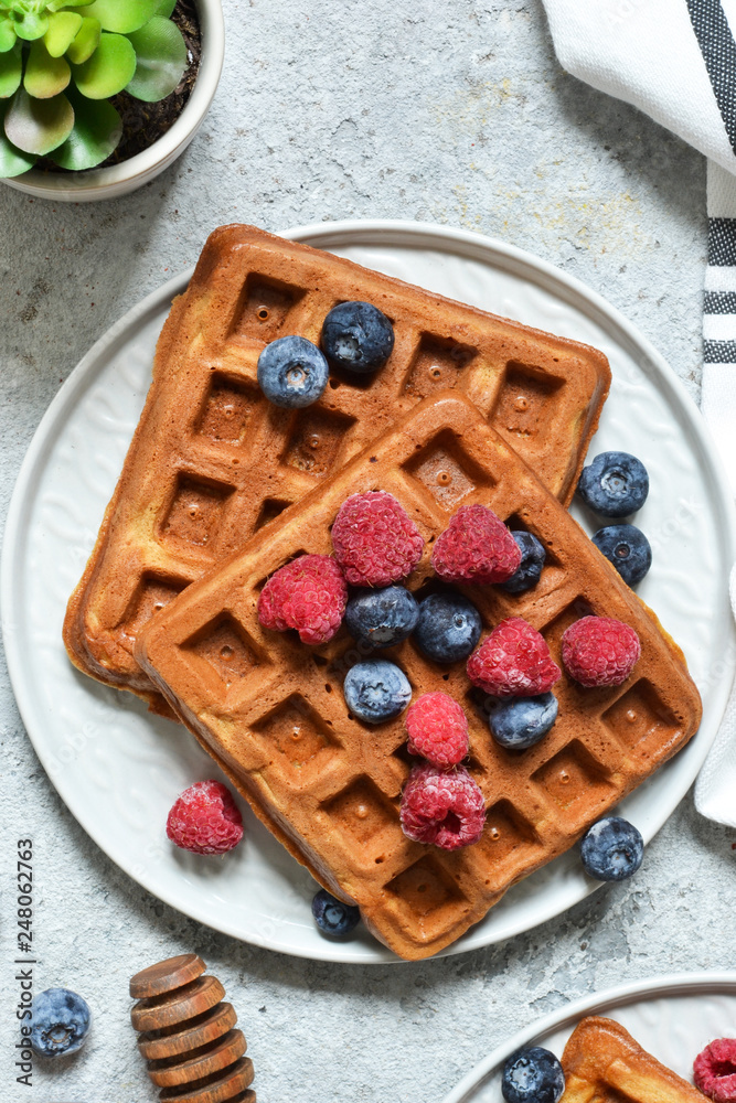 Belgian waffles on a kitchen concrete table. View from above. Belgian waffles on a kitchen concrete table. View from above.