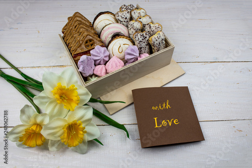 Box of sweets on a white background. with flowers. Box of cookies for Valentine's Day. With love. copy space photo