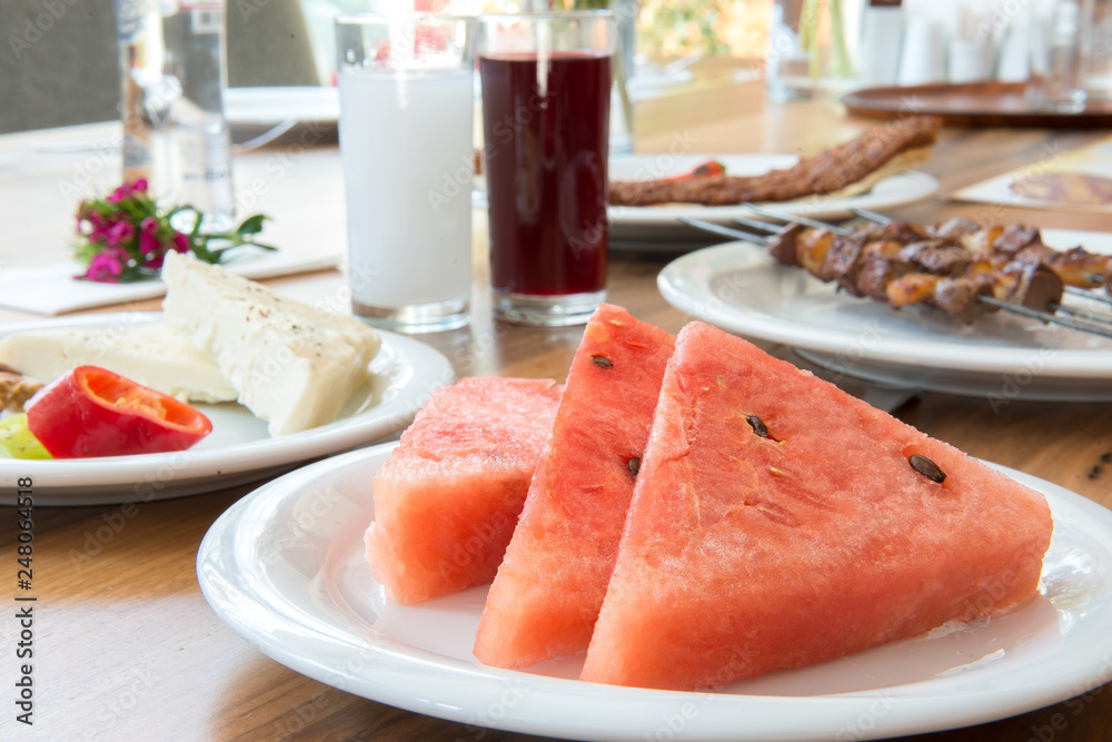 Traditional Turkish Adana Kebab or kebap meat food, raki and salgam in Turkish Restaurant with salad Traditional Turkish Adana Kebab or kebap meat food, raki and salgam in Turkish Restaurant with salad
