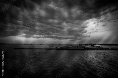 Black and white view of Punta Sabbioni and Sant Erasmo island in the Venice lagoon during a thunderstorm