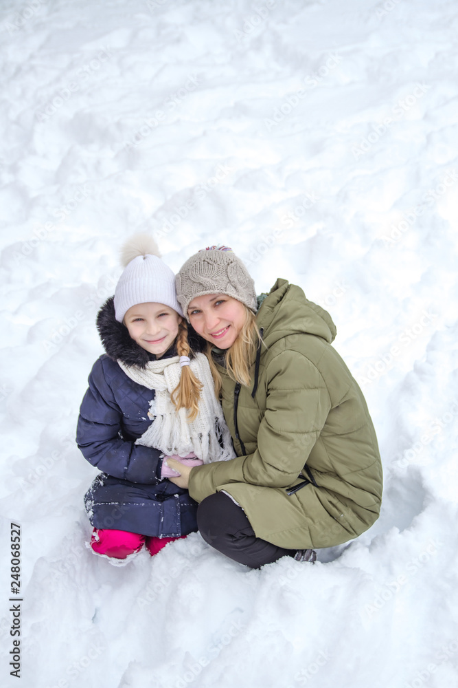 Fototapeta premium Family mother and child girl on winter walk in nature