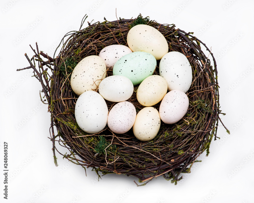 Easter eggs in the nest isolated on white background. Happy Easter! Family Traditional Decoration. Easter eggs in the nest isolated on white background. Happy Easter! Family Traditional Decoration.