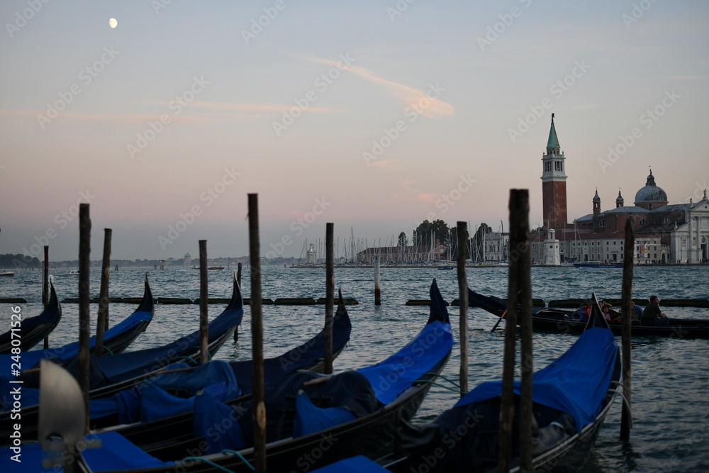 Grand Canal in Venice with gondolas at sunset and the moon