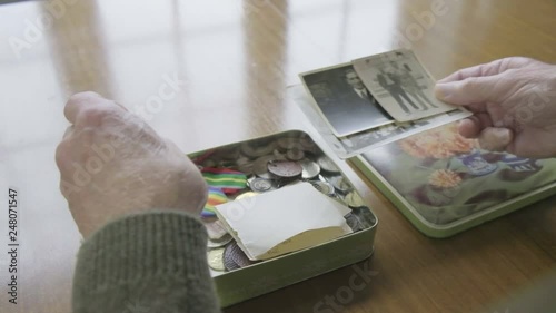 Senior caucasian man looking through a memory box themes of memories nostalgia old