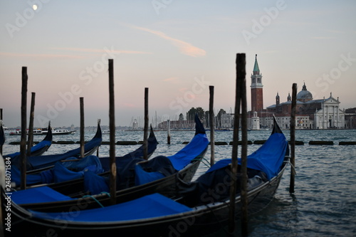 gondolas in venice in the evening the moon in the frame