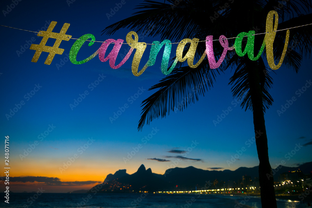 Carnival message in elegant colored gold script with a modern social media hashtag strung in front of a dusk view of Ipanema Beach in Rio de Janeiro, Brazil