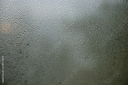 Stream drops on window glass abstract background