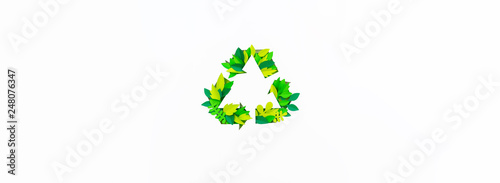 Green color recycling sign made from paper leaves. Copy Space Cut tropics plant. Banner photo