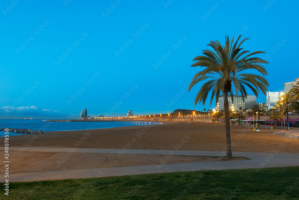 Night view of Barceloneta Beach in Barcelona with colorful sky at night. Seafront, beach,coast in Spain. Suburb of Barcelona, Catalonia