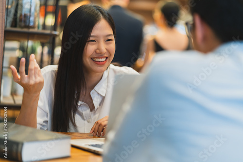 happiness asian woman and man successful informal meeting with laptop at cafe background