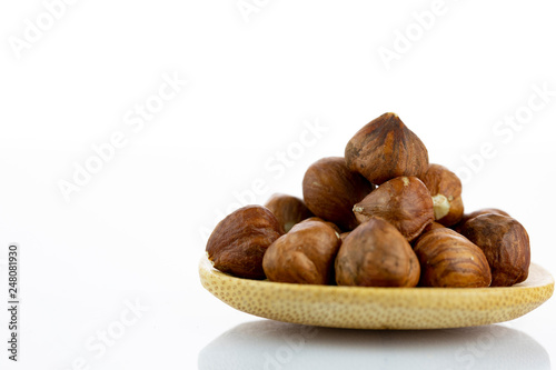 raw hazelnuts isolated on white background