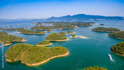 Thousand Island Lake(famous Hangzhou tourist attraction) with green mountains under blue clouds sky in zhejiang, CHIAN