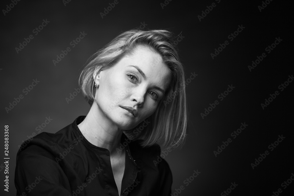 Dramatic black and white portrait of a beautiful woman on a dark background Dramatic black and white portrait of a beautiful woman on a dark background