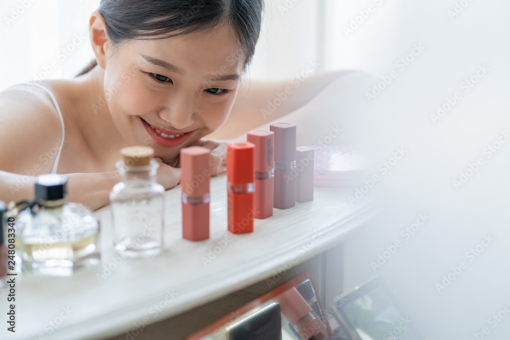 cute asian teen healthy skin enjoy laugh and smile with happiness white costume choose lipstick make up om powder table with white window curtain background cute asian teen healthy skin enjoy laugh and smile with happiness white costume choose lipstick make up om powder table with white window curtain background