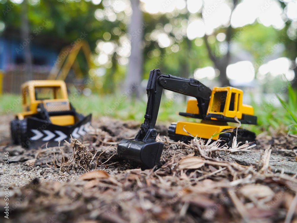 Excavation vehicle toy on the ground in the garden Excavation vehicle toy on the ground in the garden