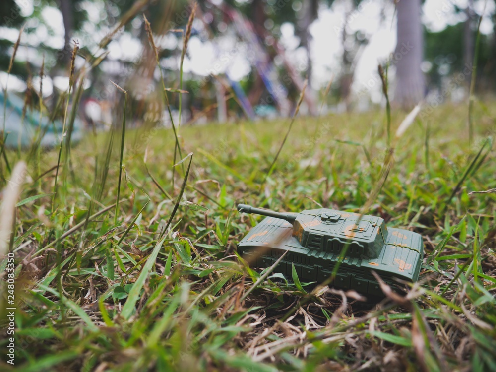 Fototapeta premium Military vehicle on the grass field
