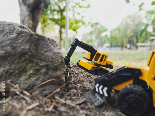 Excavation vehicle  toy on the ground in the garden