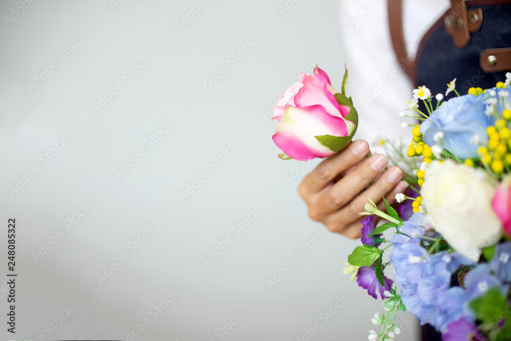 lower artist woman working to decorate  artificial flowers