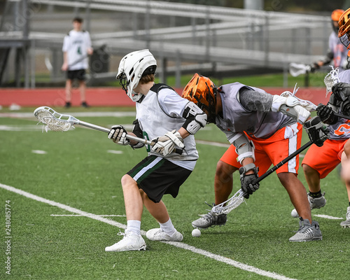 Young athletes making amazing plays while playing Lacrosse photo