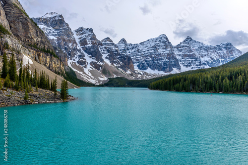 Moraine Lake at Dusk - A panoramic view of emerald-color Moraine Lake and its surrounding rugged high peaks on a calm Spring evening, Banff National Park, AB, Canada.