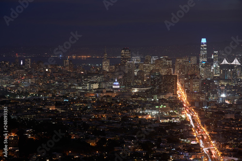 Downtown San Francisco skyline and city lights at night with the city hall in the center.