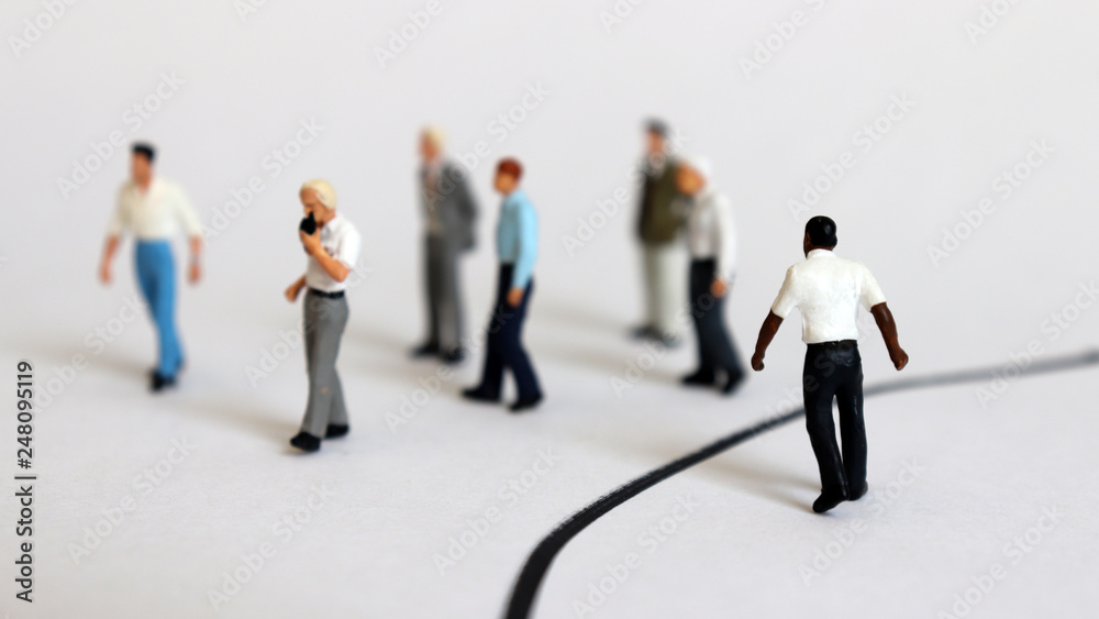 The concept of racial discrimination in society. Miniature people. The concept of racial discrimination in society. Miniature people.