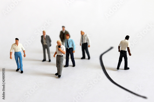 The concept of racial discrimination in society. Miniature people. 