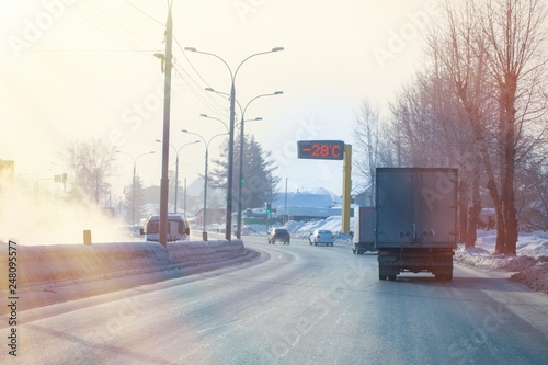 Photography winter cold and smog on the roads, road thermometer shows sub-zero temperature