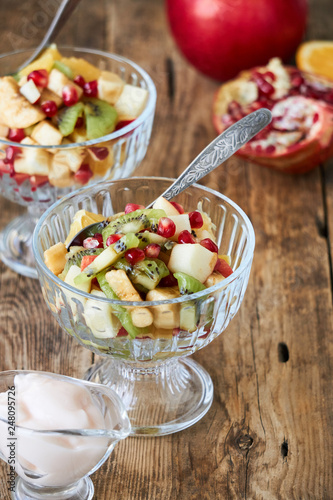 Salad with various fresh fruits in glass bowls