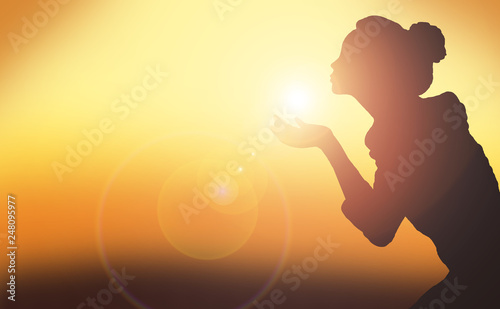Silhouette of a girl on a sunset background, holding a ray, magic, light