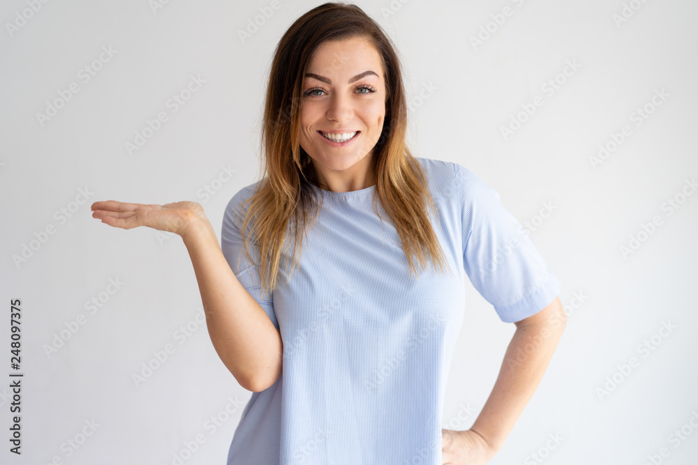 Smiling pretty woman holding empty space on palm Smiling pretty woman holding empty space on palm