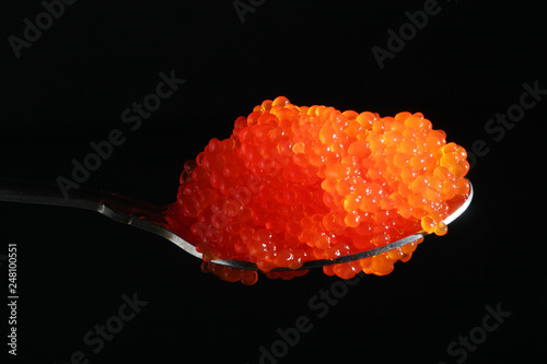 A spoon with red caviar
