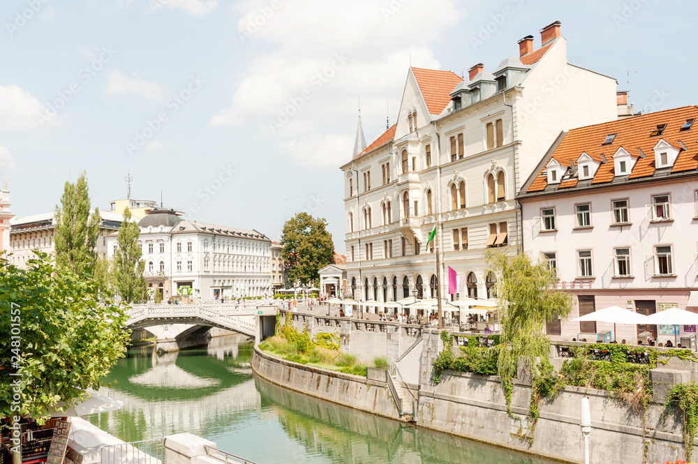 Restaurants and cafes along Ljubljanica river with famous Triple bridge in the center of Ljubljana, Slovenia