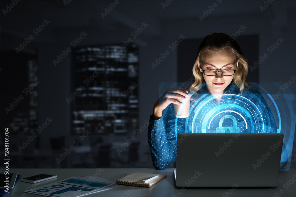Beautiful blonde in dark office working on laptop and getting net access Beautiful blonde in dark office working on laptop and getting net access