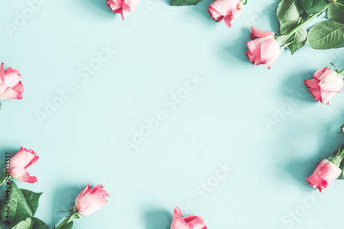 Flowers composition. Pink rose flowers on pastel mint background. Valentines day, mothers day, womens day, spring concept. Flat lay, top view, copy space