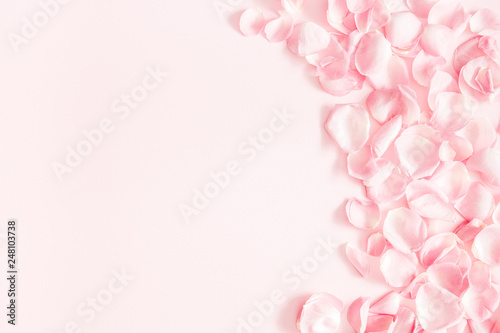 Flowers composition. Rose flower petals on pastel pink background. Valentines day, mothers day, womens day, wedding concept. Flat lay, top view, copy space