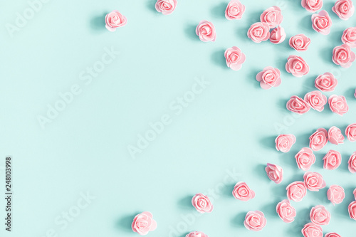 Flowers composition. Pink rose flowers on pastel blue background. Valentines day, mothers day, womens day, spring concept. Flat lay, top view, copy space