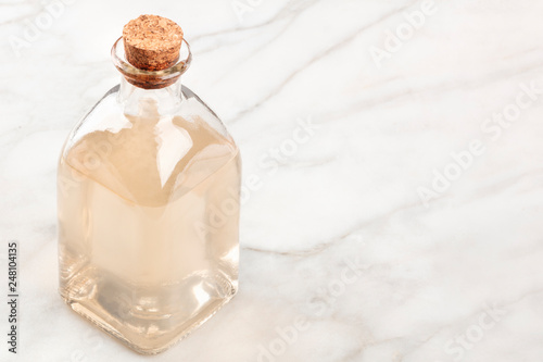 A photo of a corked bottle of homemade rosewater face toner with copy space photo