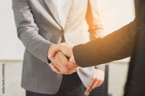 business man and woman shaking hands