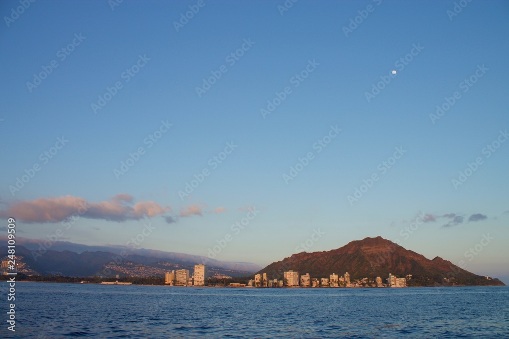 Looking back at Diamond Head Crater from a catamaran sailing on the ocean
