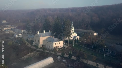 Aerial view of christian monastery on the shore of the lake, covered with fog. Thiganesty monastery. Moldova republic of. photo