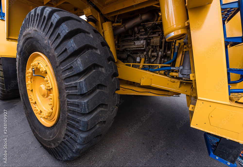 Huge wheels of a yellow dump truck