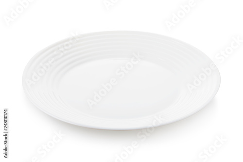 Empty white ceramic plate with embossed edges. Side view of an isolated object