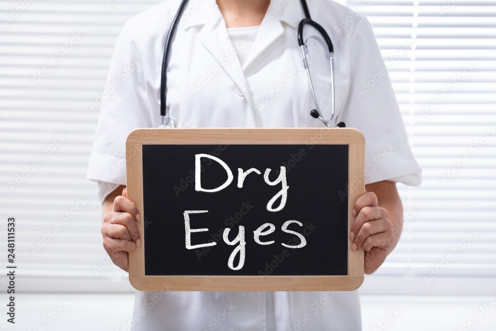 Female Doctor Holding Slate With Dry Eyes Text Female Doctor Holding Slate With Dry Eyes Text