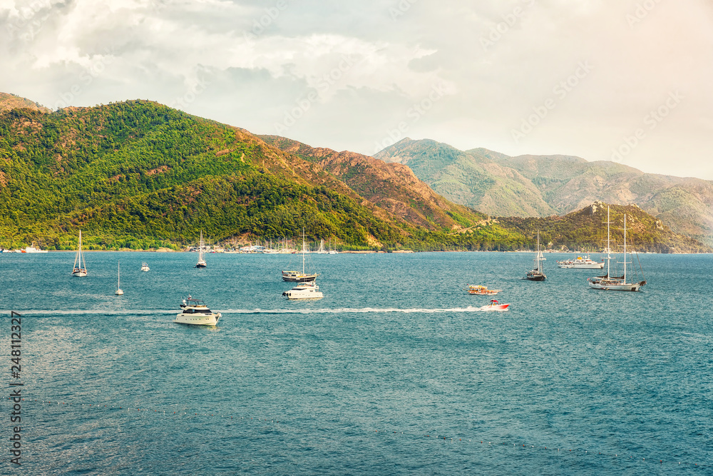 Beautiful Panoramic Aerial view at of boats, yacht, sailboat and bay in Marmaris, Turkey. Colorful landscape with boats in marina bay, sea, city, mountains