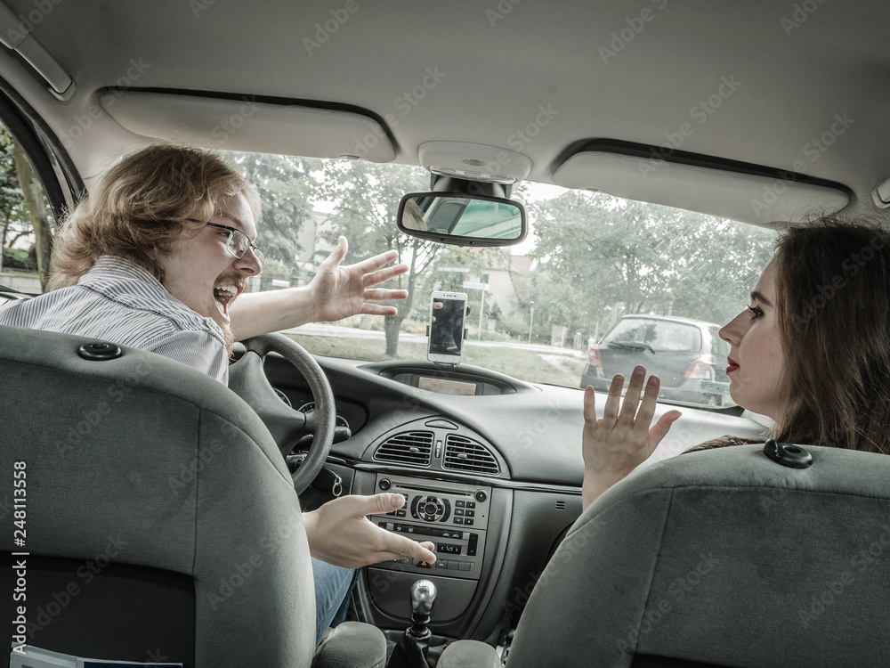 Displeased woman in car with boyfriend