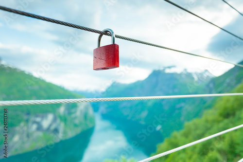 Red padlock and Geirangerfjord from Flydasjuvet viewpoint Norway