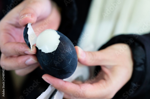 Peel boiled black egg, Black egg of hot springs Owakudani, Hakone, Japan